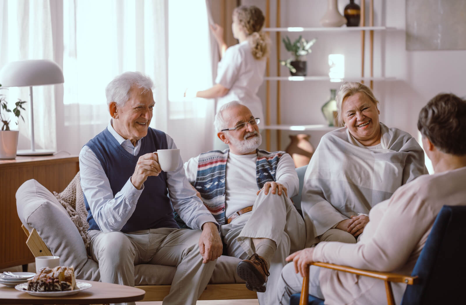 A group of happy older adults lounging and having a fun conversation.